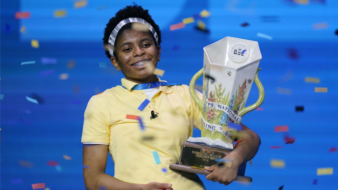 Zaila Avant-garde, 14, from Harvey, Louisiana celebrates with the championship trophy after winning the finals of the 2021 Scripps National Spelling Bee at Disney World Thursday, July 8, 2021, in Lake Buena Vista, Fla. (AP Photo/John Raoux)