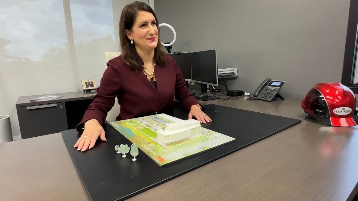 President Dr. Angela Falconetti is pictured with a model of the Haines City- Davenport campus. (Spectrum Bay News 9/Alexis Jones)