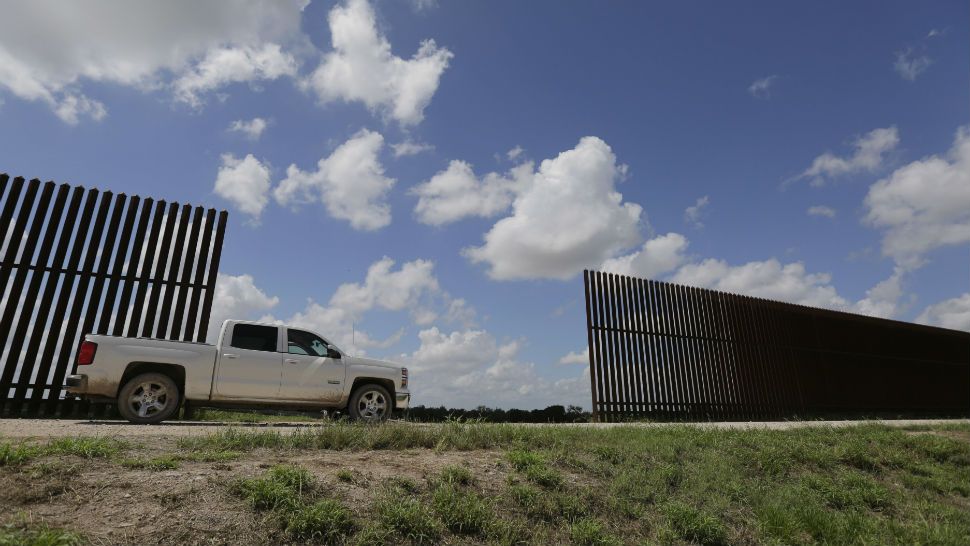 Truck drives by U.S.-Mexico border (Spectrum News file image)