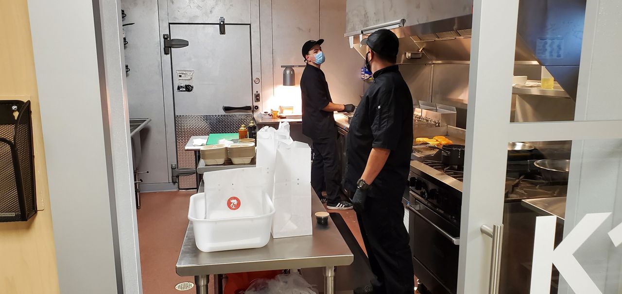 People prepare food in a shared kitchen in Austin, Texas (Agustin Garfias/Spectrum News)