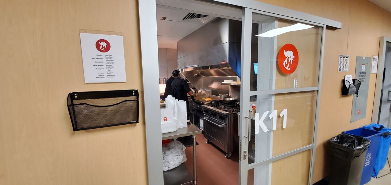 People prepare food in a shared kitchen in Austin, Texas (Agustin Garfias/Spectrum News)