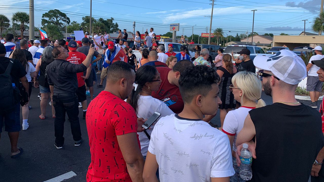 Around 100 people rally in Orlando for Cuban protesters Sunday. They say they will rally again on Tuesday. (Spectrum News/Emily Braun)