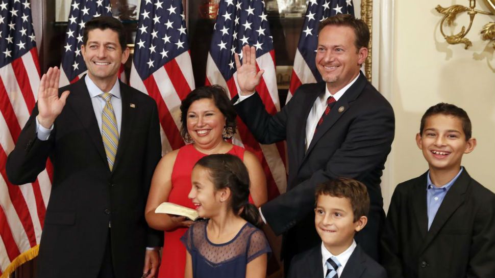 House Speaker Paul Ryan of Wis., left, stands with Rep.-elect Michael Cloud, R-Texas, back right, and his wife Rosel Cloud, back center, and children Zoe Cloud, Kent Cloud, and Ean Cloud, far right, during a mock swearing-in ceremony on Capitol Hill, Tuesday, July 10, 2018, in Washington. (AP Photo/Alex Brandon)