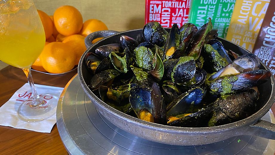 Vibrant green dressing clothes the mussels at well-known Spanish chef's Disney Springs restaurant. (Allison Walker/Spectrum News)