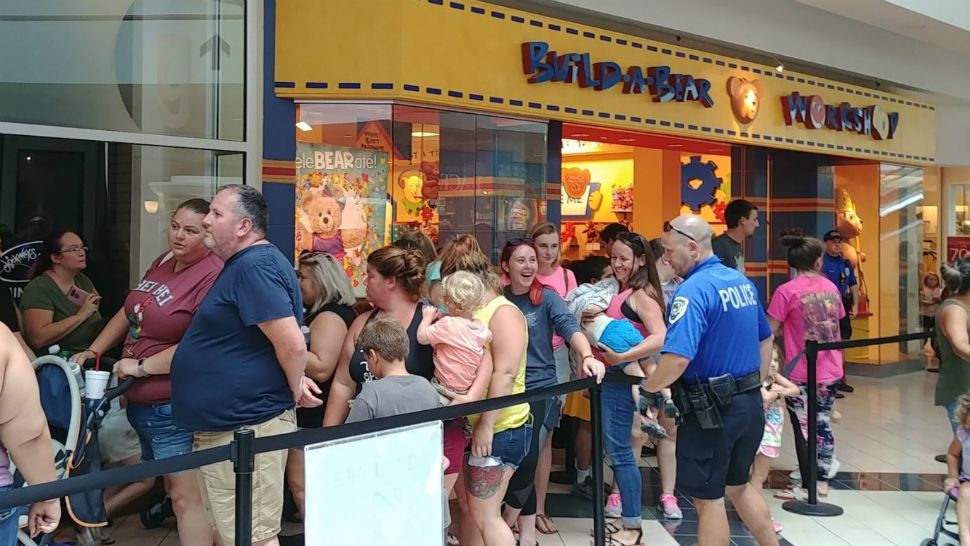 Altamonte Springs Police manage long lines in front of the Build-A-Bear Workshop store in the Altamonte Mall on Thursday, July 12, 2018, during a "Pay Your Age Day" company promotion. (Ashley Carter, staff)