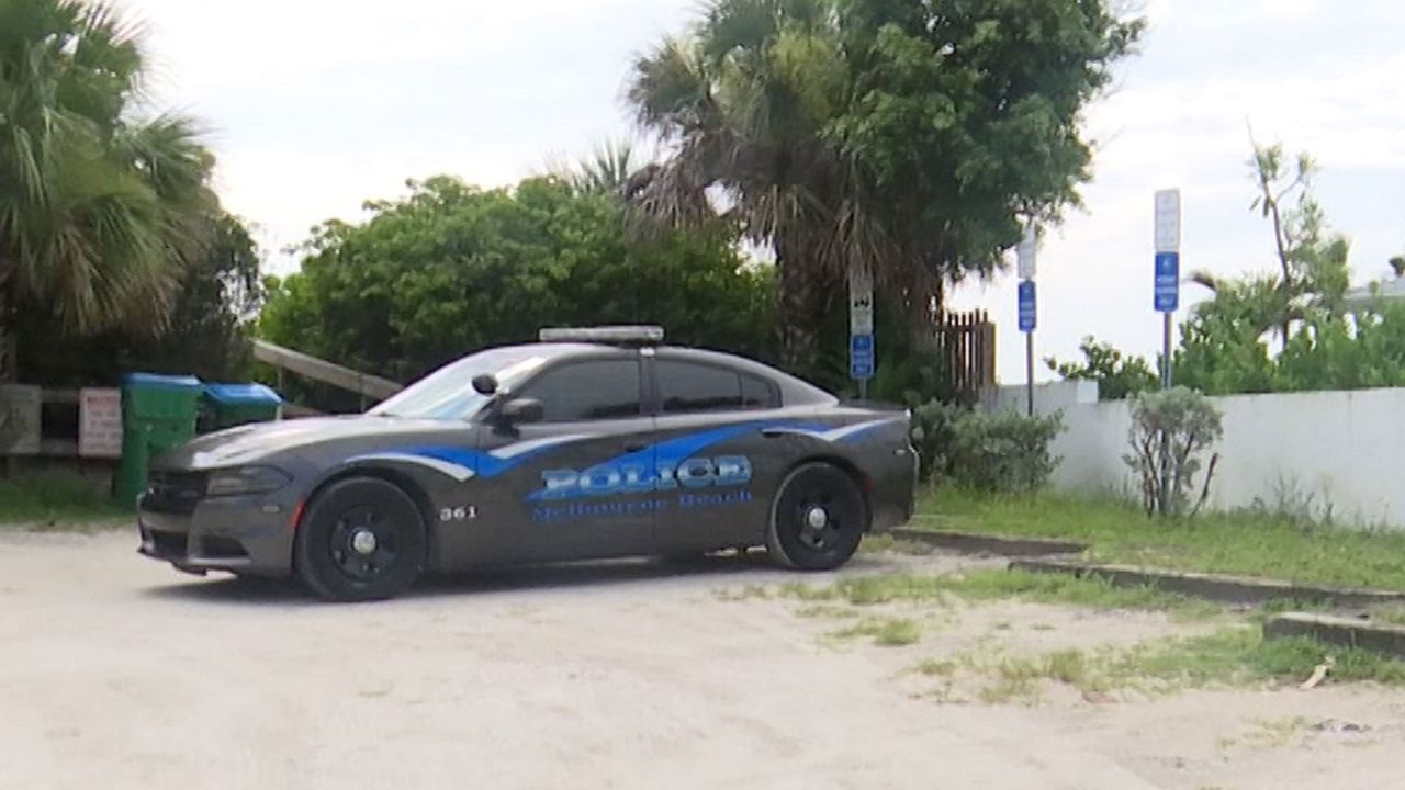 A Melbourne Beach police cruiser parked near beach parking spots designated for city residents only. (Krystel Knowles/Spectrum News 13)