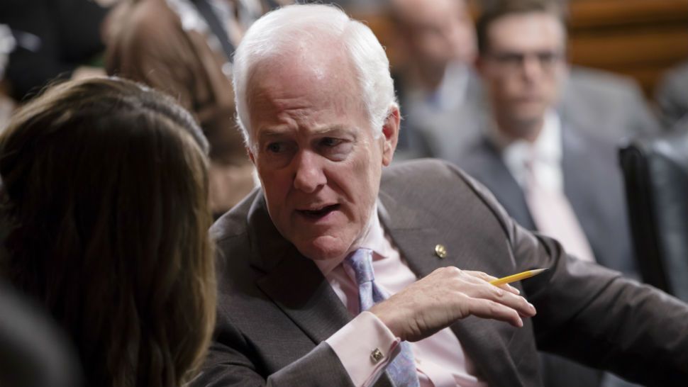 Sen. John Cornyn, R-Texas, the number two Republican in the Senate, speaks with an aide during a Senate Judiciary Committee markup session to vote on new federal judges, on Capitol Hill in Washington, Thursday, June 28, 2018. (AP Photo/J. Scott Applewhite)