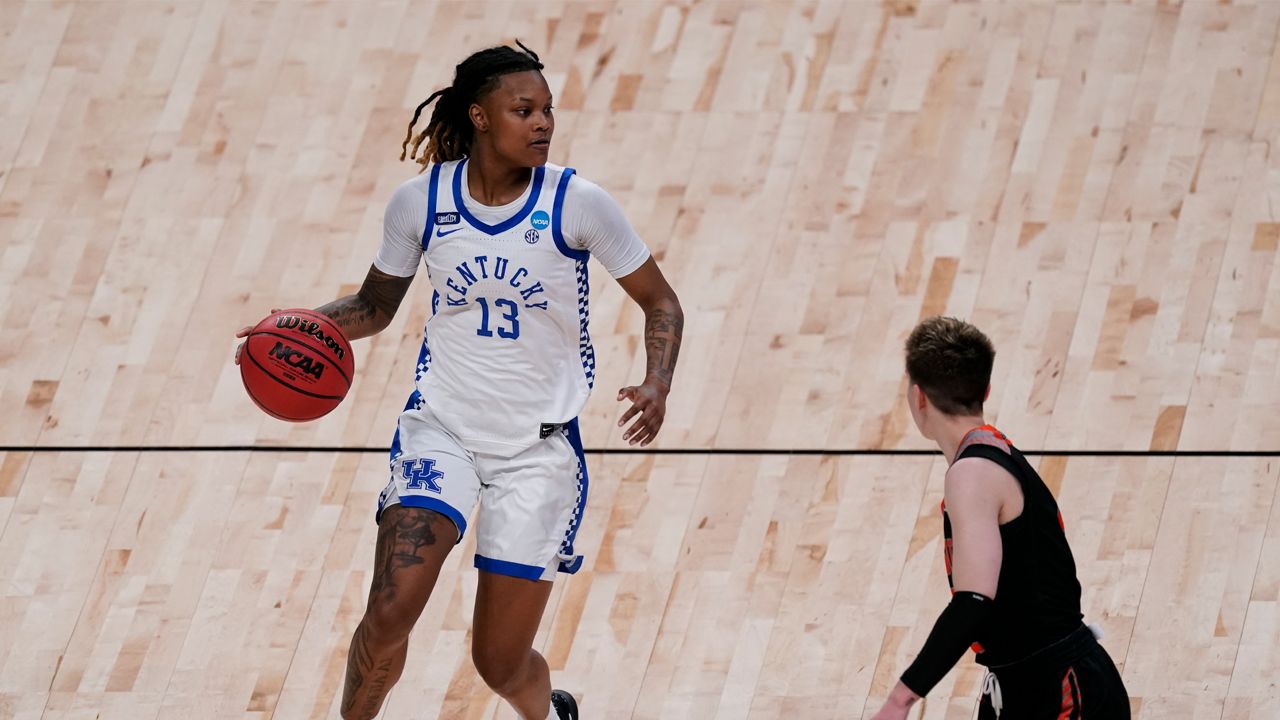 Kentucky guard Jazmine Massengill (13) drives past Idaho State guard Dora Goles during the first half of a college basketball game in the first round of the women's NCAA tournament at the Alamodome in San Antonio, Sunday, March 21, 2021. (AP Photo/Charlie Riedel)