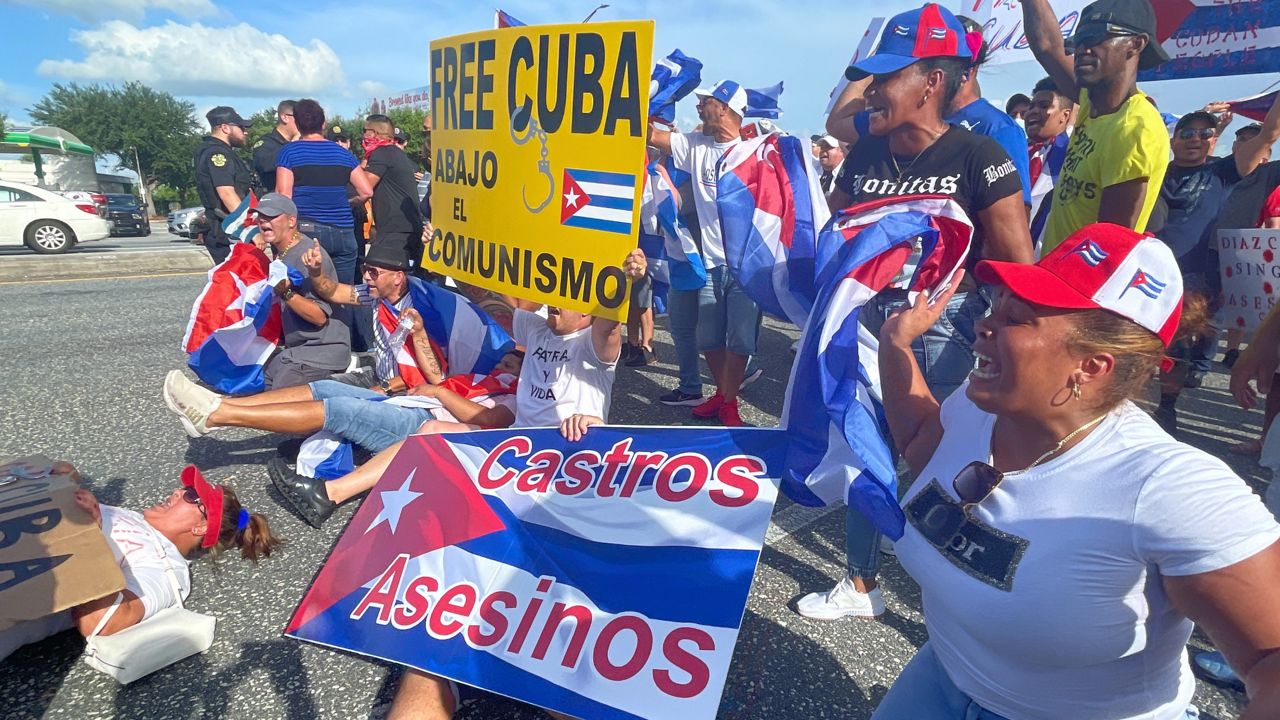 Demonstrators pushing for freedom for Cuban people spill out onto South Semoran Boulevard on Tuesday afternoon. (Spectrum News 13/Jesse Canales)
