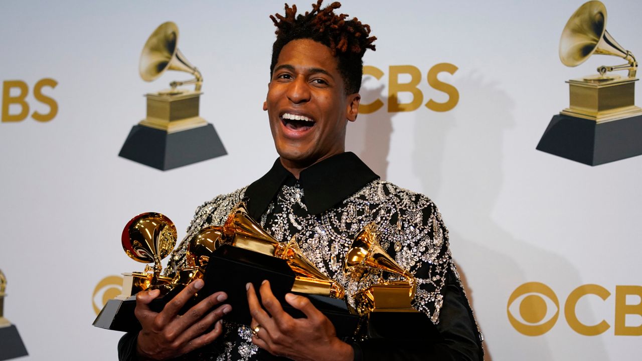 Jon Batiste, winner of the awards for best American roots performance for "Cry," best American roots song for "Cry," best music video for "Freedom," best score soundtrack for visual media for "Soul," and album of the year for "We Are," poses in the press room at the 64th Annual Grammy Awards at the MGM Grand Garden Arena on Sunday, April 3, 2022, in Las Vegas. (AP Photo/John Locher)