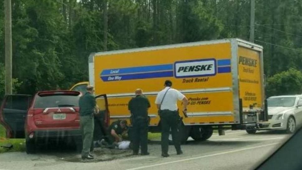 The 3 occupants of a stolen SUV are taken into custody Sunday after the SUV crashed into a Penske rental truck. (Flagler County Sheriff's Office)