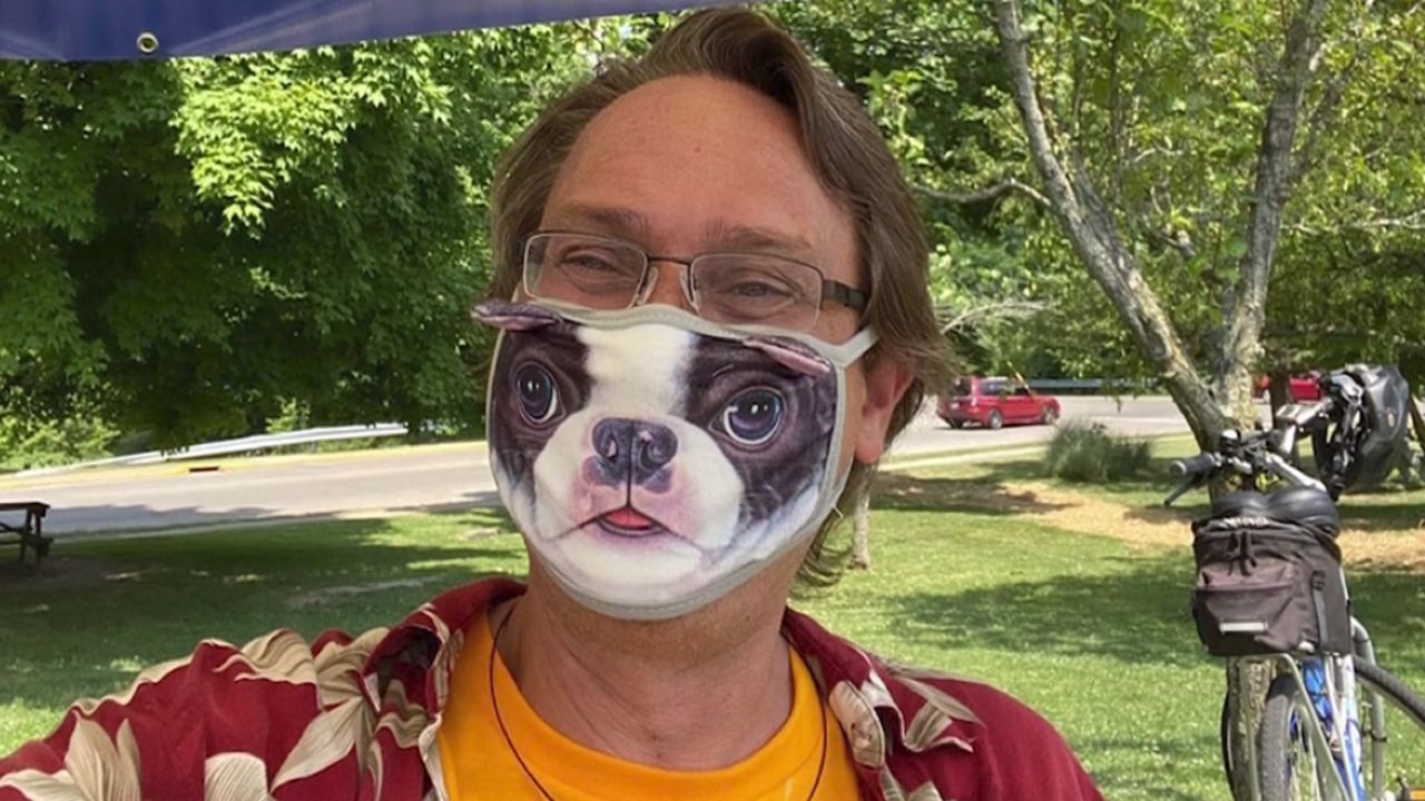 man wearing a facemask with a dog's face on it