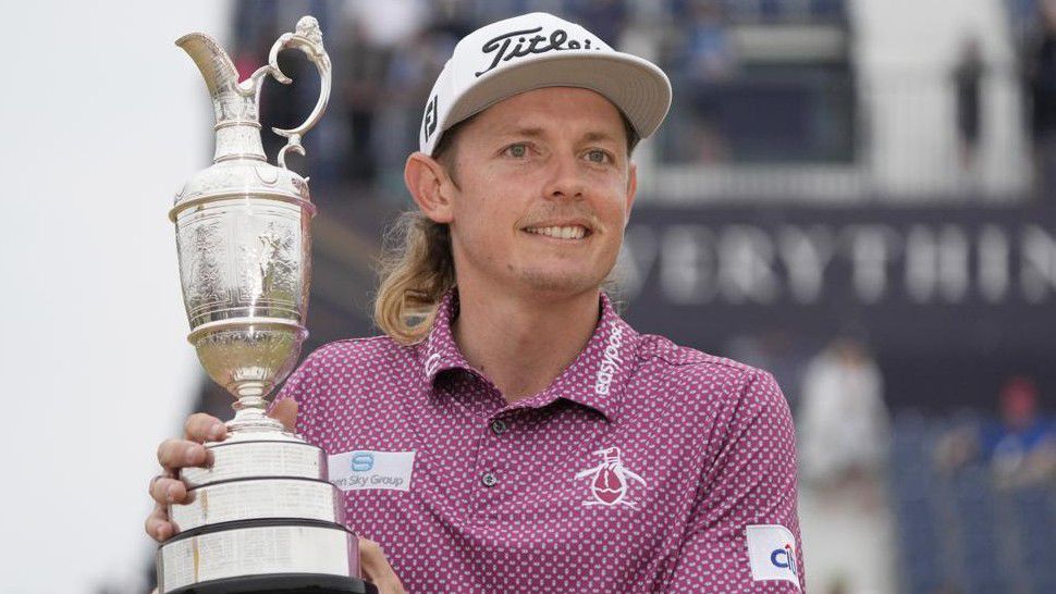 Cameron Smith, of Australia, holds the claret jug trophy as he poses for photographers on the 18th green after winning the British Open golf Championship on the Old Course at St. Andrews, Scotland, Sunday July 17, 2022. (AP Photo/Gerald Herbert)