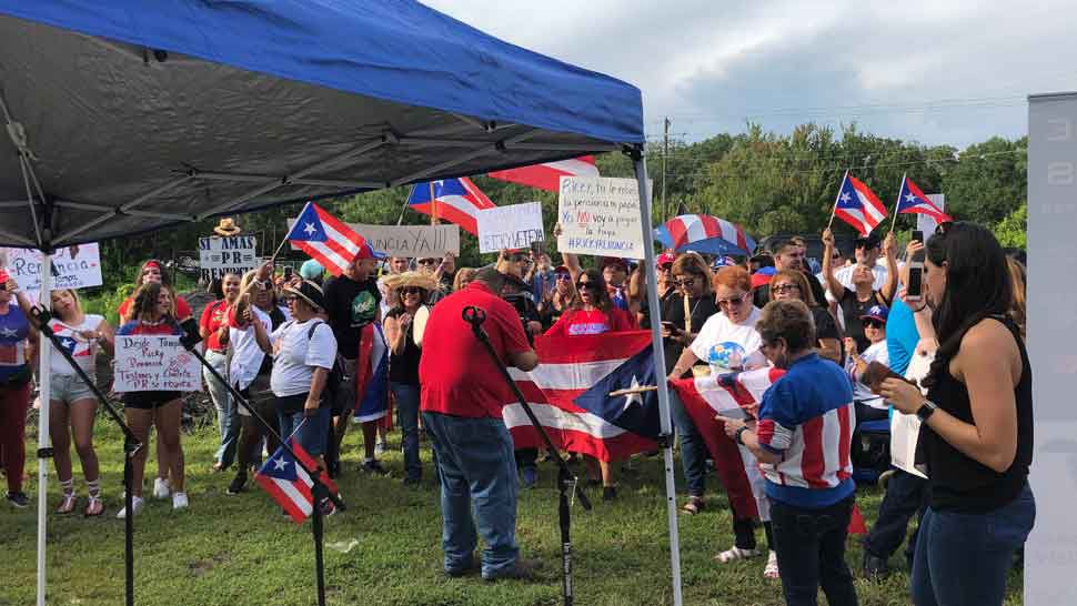 Members of the Bay area's Puerto Rican community gather on Gunn Highway in Tampa to protest ongoing scandals on the island. (Laurie Davison/Spectrum Bay News 9)