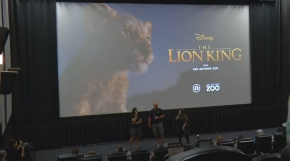 San Antonio Zoo employees stand in front of an audience inside an Alamo Drafthouse theater prior to The Lion King moving showing July 19, 2019 (Spectrum News)