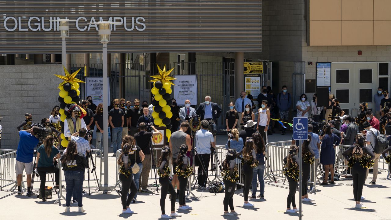 Los Angeles Unified School District officials and students hold a news conference to announce a school-based COVID-19 vaccination event for students 12 and older in San Pedro, Calif., Monday, May 24, 2021. (AP Photo/Damian Dovarganes) 