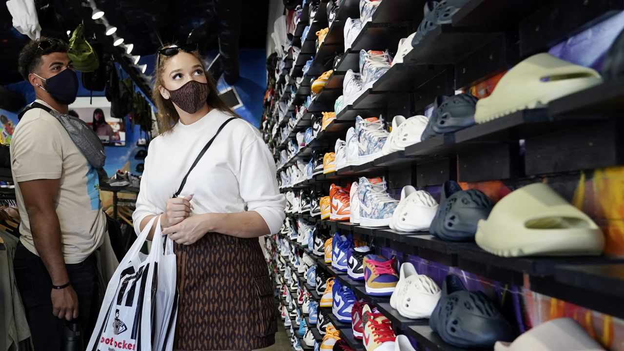Shoppers wear masks inside of The Cool store Monday, July 19, 2021, in the Fairfax district of Los Angeles. (AP Photo/Marcio Jose Sanchez)