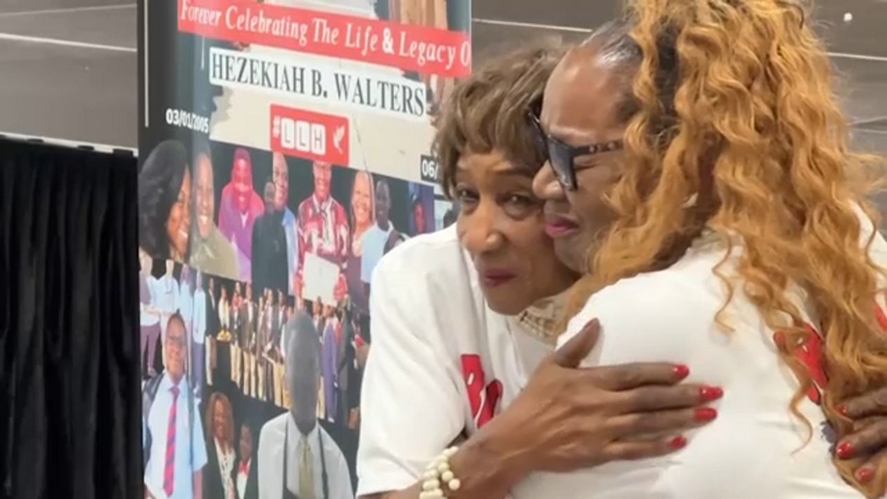 Phyllis Walters (right) hugs a family member during a CPR education event Monday at The Skills Center in Tampa. (Spectrum Bay News 9)