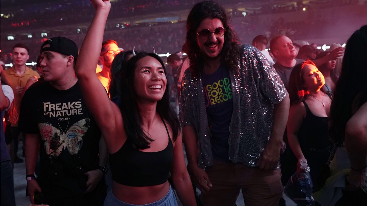 Fans dance during electronic music producers Deadmau5's performance at SoFi Stadium, Saturday, July 17, 2021, in Los Angeles. (AP Photo/Chris Pizzello)