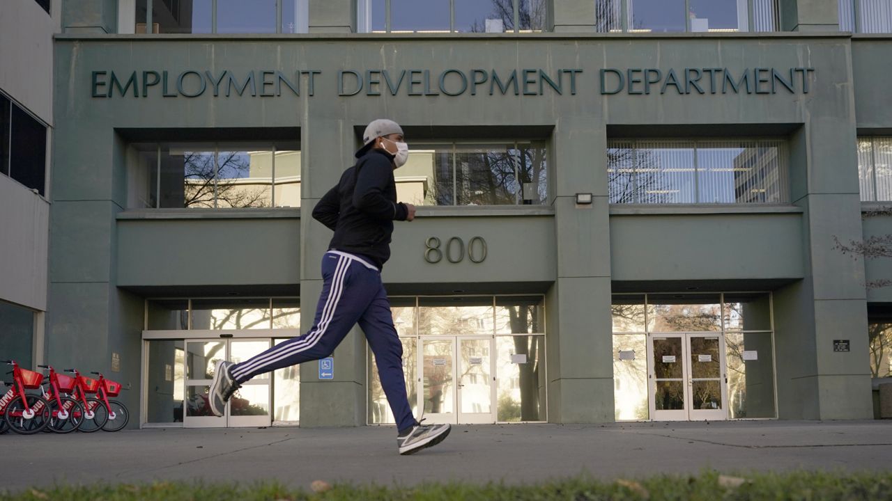 A runner passes the office of the California Employment Development Department in Sacramento, Calif. on Dec. 18, 2020. (AP Photo/Rich Pedroncelli)