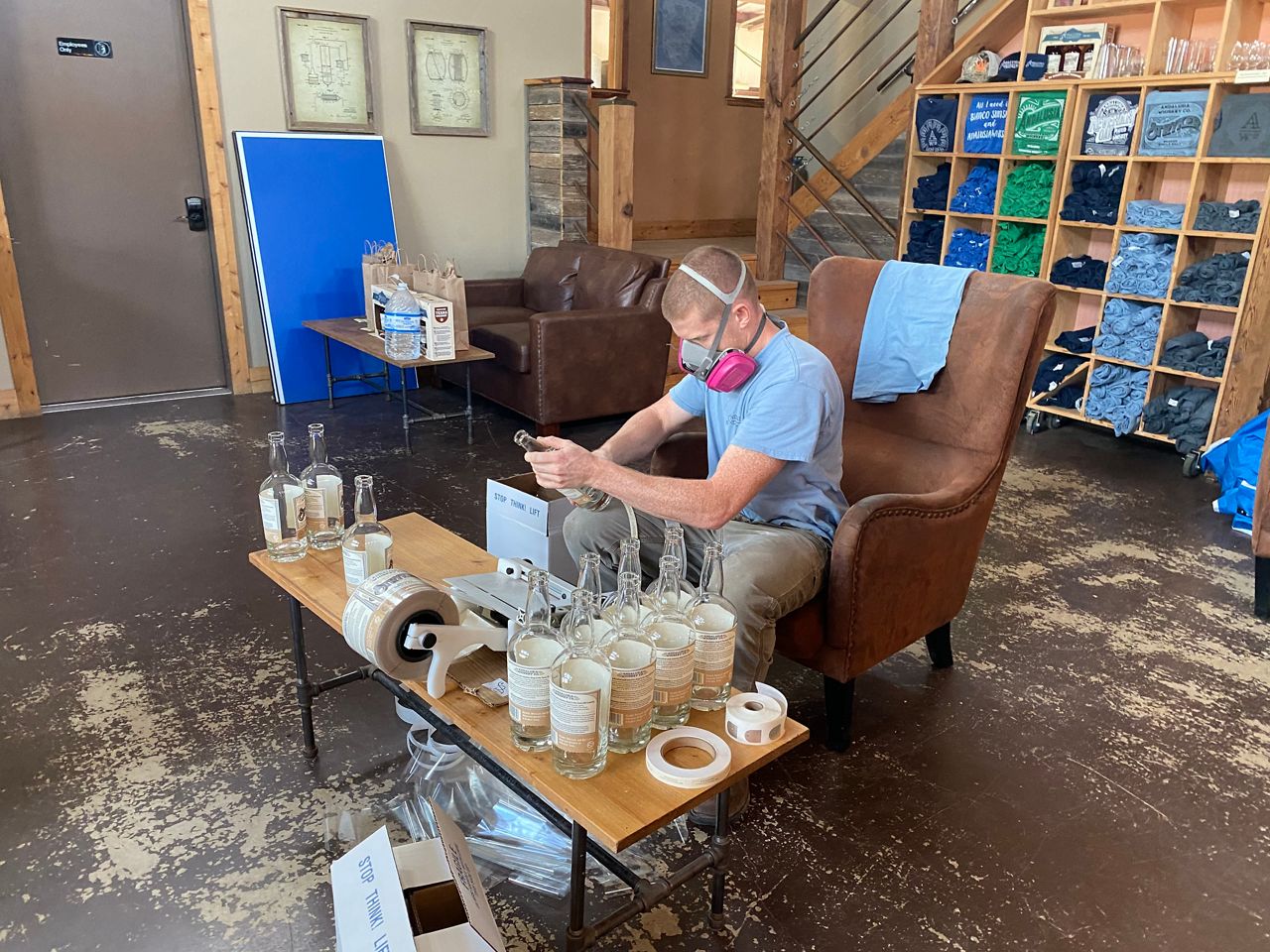 Andalusia Whiskey’s tasting room is closed, so it’s now being used as part of the production process including labeling. (Reena Diamante/Spectrum News)