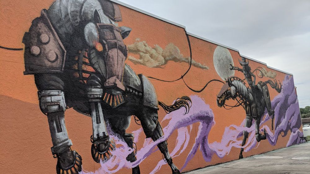 The "Unbridled Future" by Christian Stanley is one of four new murals in downtown Kissimmee. (Ybeth Bruzual, Spectrum News)