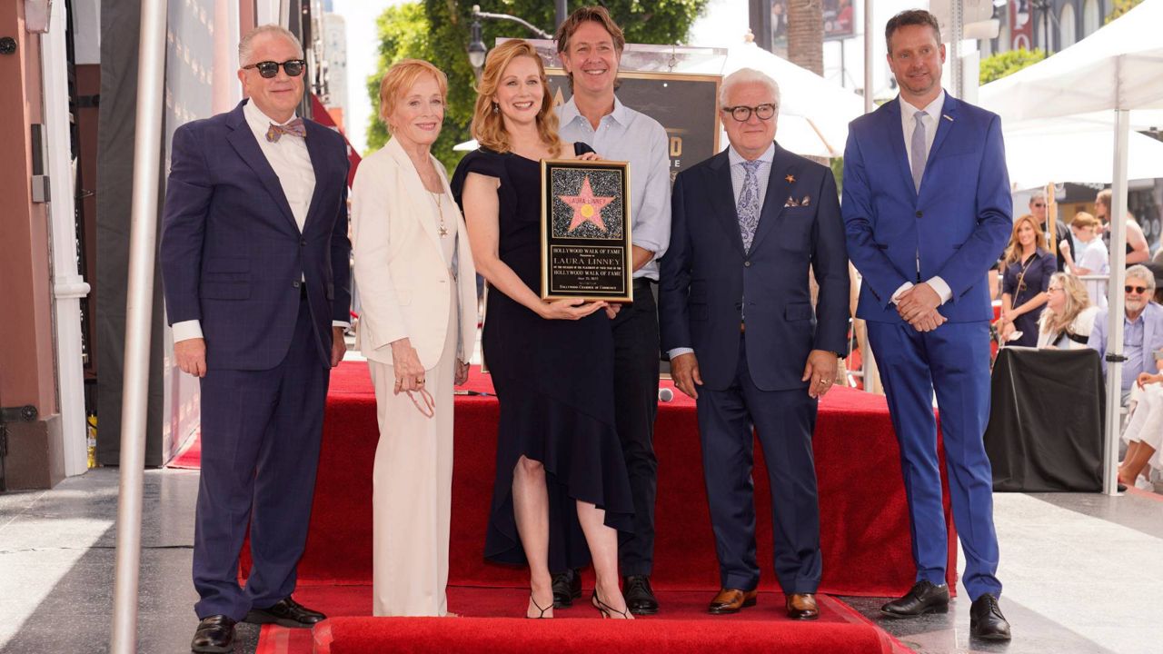 From left, David Michael Jerome, President/CEO of the Hollywood Chamber of Commerce, actor Holland Taylor, actor Laura Linney, Ozark producer and writer Chris Mundy, producer Vin Di Bona, and Hollywood Chamber Board Member William Grice, unveil the Hollywood Walk of Fame Star honoring Linney on Monday in Los Angeles. (AP Photo/Damian Dovarganes)