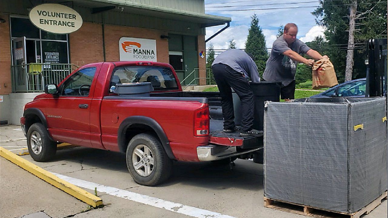 Asheville Tourists donate more than 700 pounds of canned goods to Manna Foodbank. 