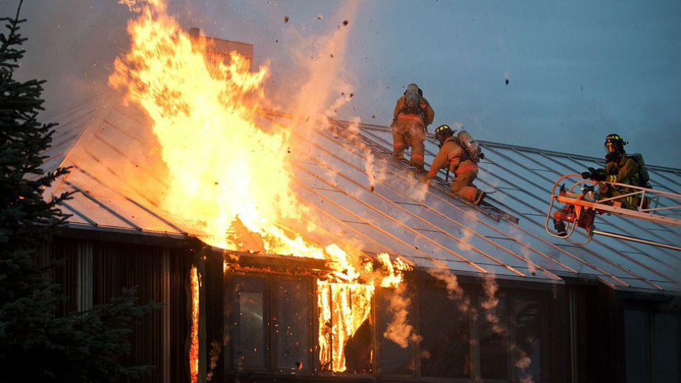 FILE photo of firefighters working to control a house fire. 