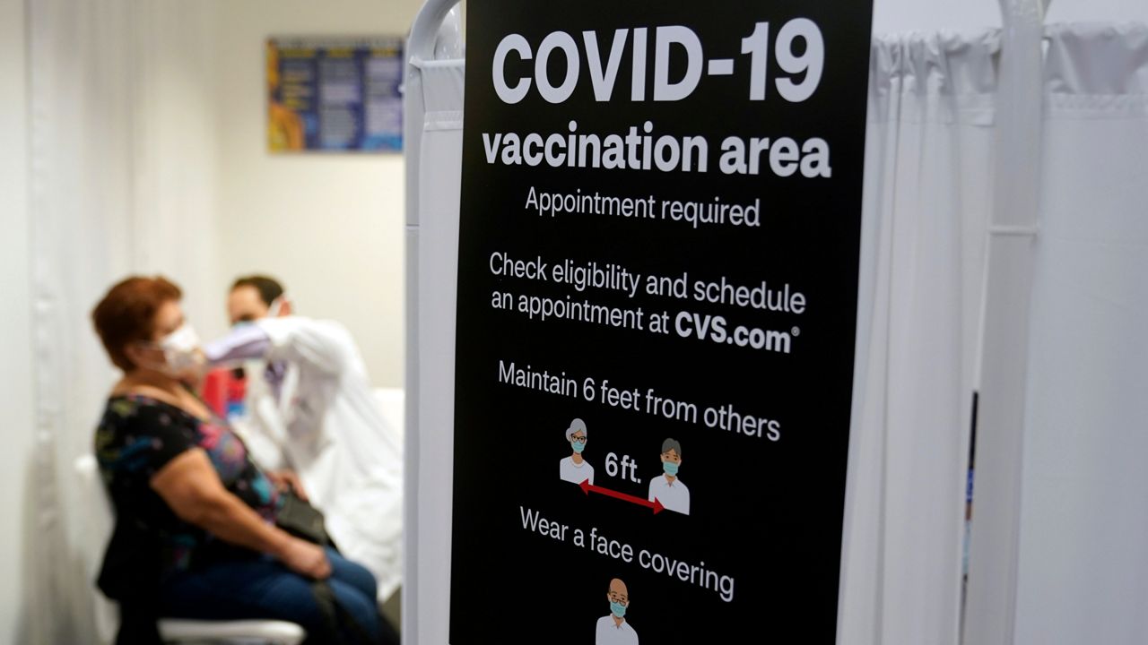 A patient receives a shot of the Moderna COVID-19 vaccine at a CVS Pharmacy branch in Los Angeles. (AP Photo/Marcio Jose Sanchez, File)