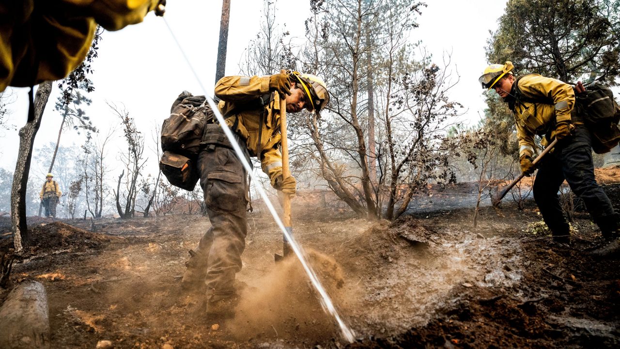 Firefighter Sergio Porras mops up hot spots while battling the Oak Fire in the Jerseydale community of Mariposa County, Calif., on Monday, July 25, 2022. (AP Photo/Noah Berger)