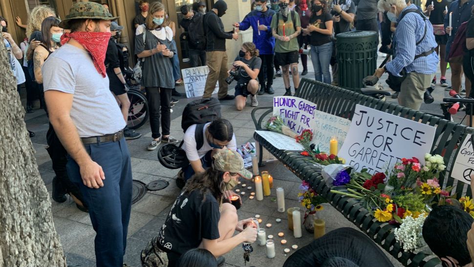 People gather around a memorial for Garrett Foster, who was shot and killed suring a protest on July 25. (Niki Griswold/Spectrum News)
