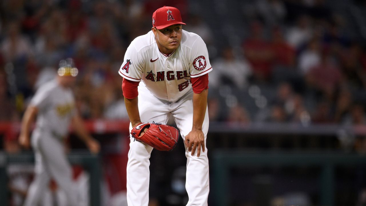 Angels relief pitcher Jose Quintana reacts after a throwing error on a pickoff attempt to first base resulting in a run scored by the Athletics in Anaheim, Calif., Thursday, July 29, 2021. (AP Photo/Kelvin Kuo)