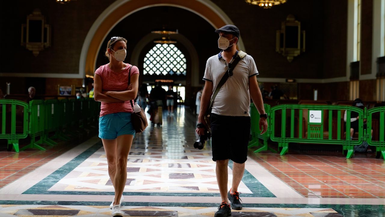 Visitors wear masks inside Union Station Thursday, July 28, 2022, in Los Angeles. Health officials in Los Angeles County are debating a decision to reinstate an indoor mask mandate Thursday. (AP Photo/Marcio Jose Sanchez)