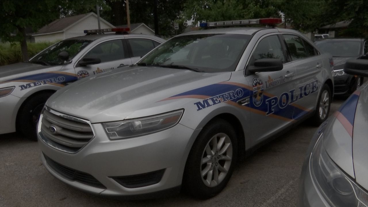 A Louisville Metro Police Department cruiser sits in a parking lot. (Spectrum News 1/Brennon Gurley)