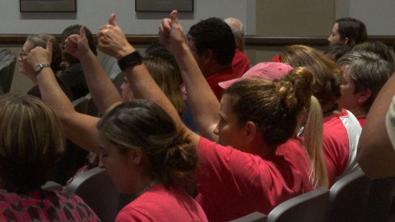 Orange County teachers wore red to the board meeting to show the need for fair pay. (Eric Mock/Spectrum News 13)