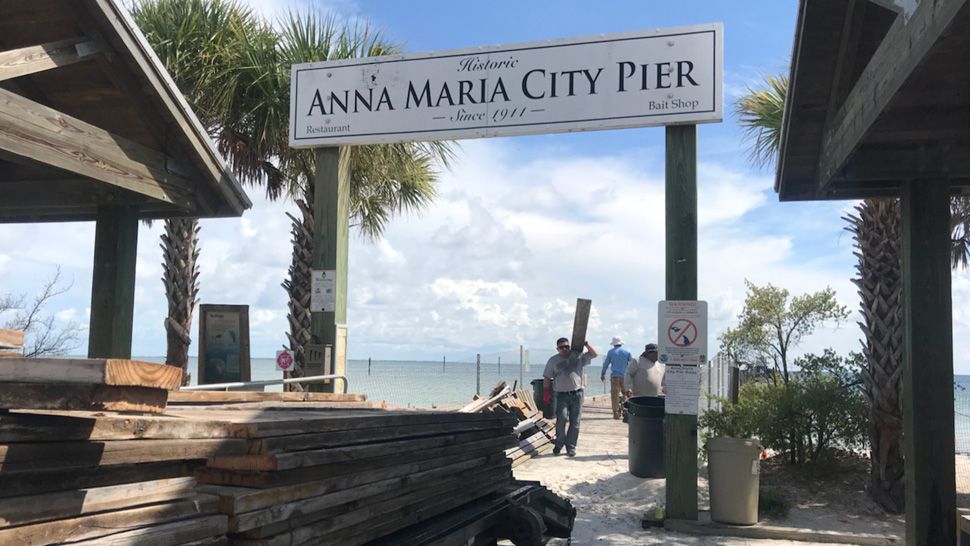 Memorial planks stacked outside the entrance to the Anna Maria City Pier, Wednesday, July 18, 2018. The engraved planks, purchased by residents during the pier's centennial, were carefully cut and lifted from the walkway as demolition work on the old pier continued. (Angie Angers, staff)