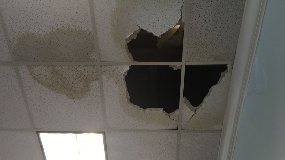 Water damage visible to ceiling tiles at the Main Brooksville Library in downtown Brooksville, Monday, July 30, 2018. (Kim Leoffler, staff)