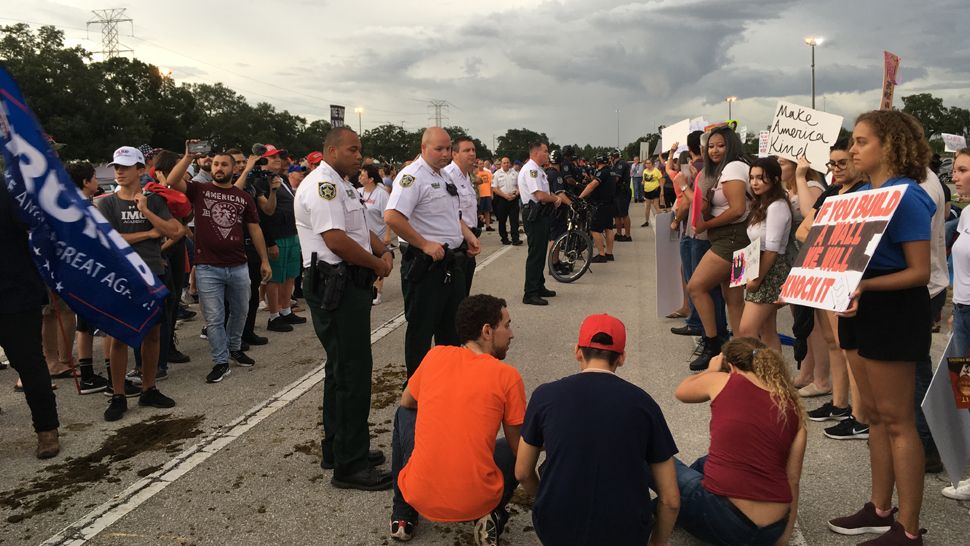 Tampa Police form a line to separate supporters of President Donald Trump from protesters outside a rally at the Florida State Fairgrounds, Tuesday, July 31, 2018. (Laurie Davison, staff)