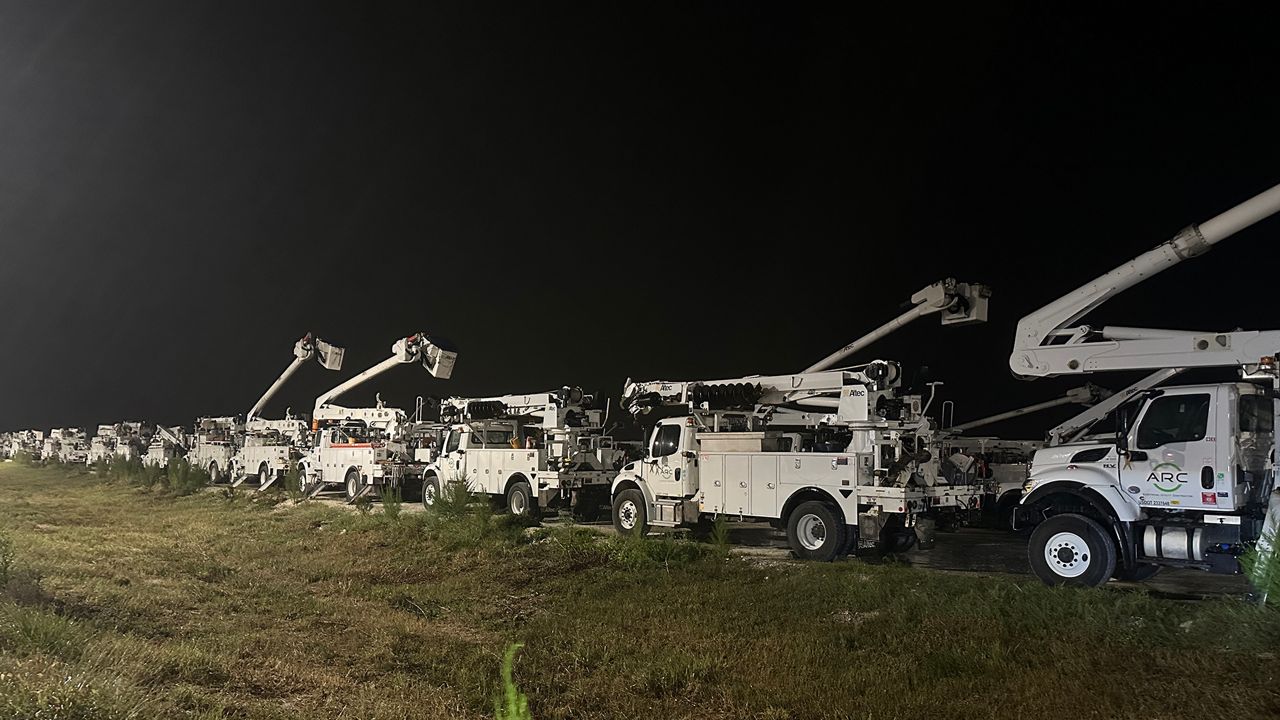 Power company trucks are at the ready to deal with any possible power outages. (Spectrum News)