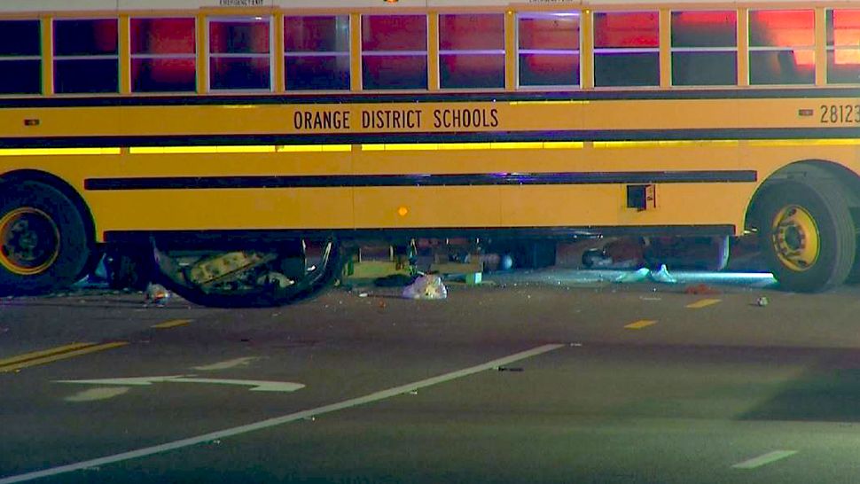 A car thought to be involved in a street race crashed into a school bus pulling out of a facility late Thursday. The driver of the car, which went partially underneath the bus, was in critical condition. (Ken Ashlin, staff)