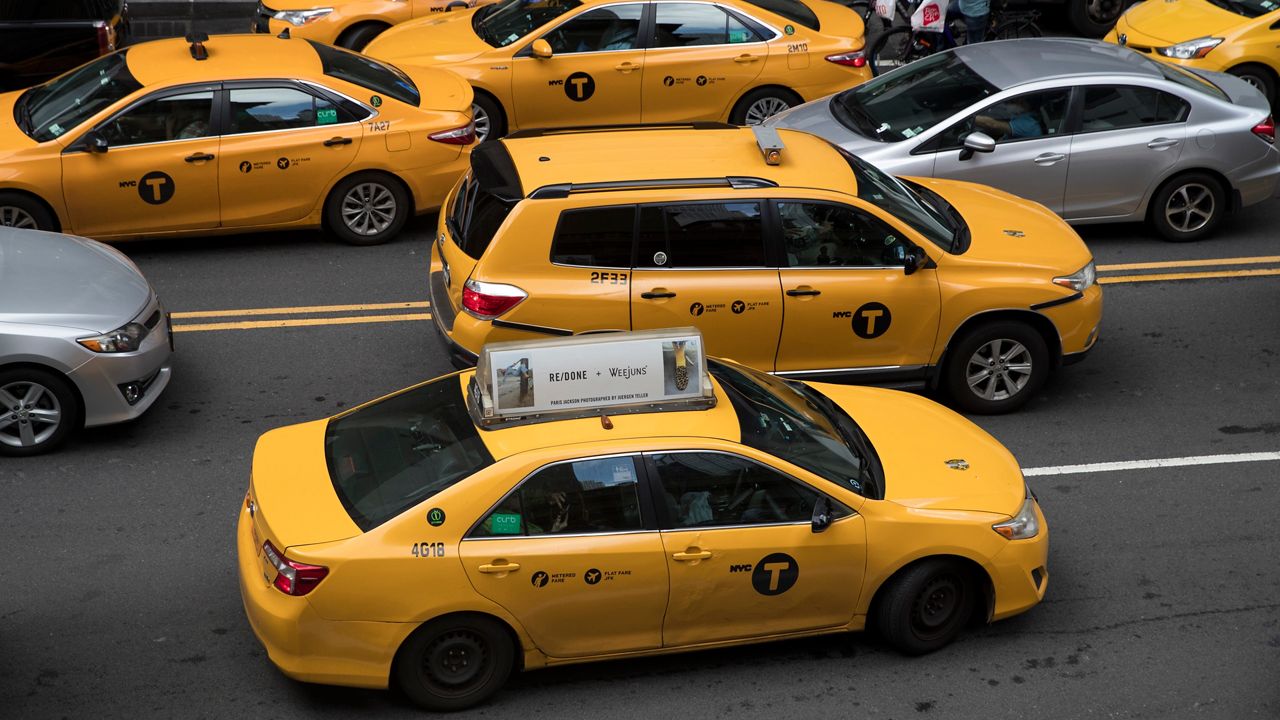 In this Aug. 1, 2018 photo, yellow cabs make their way across 42nd Street outside Grand Central Terminal in New York.