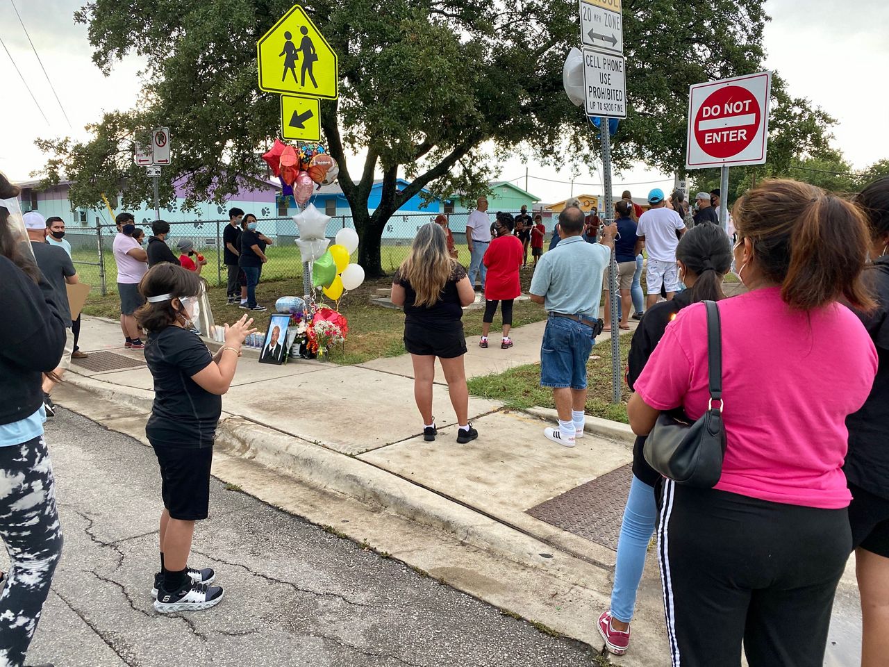 People gather at a vigil on July 31 for crossing guard Robert Mata, outside of Barrington Elementary in Austin, Texas (Reena Diamante/Spectrum News)