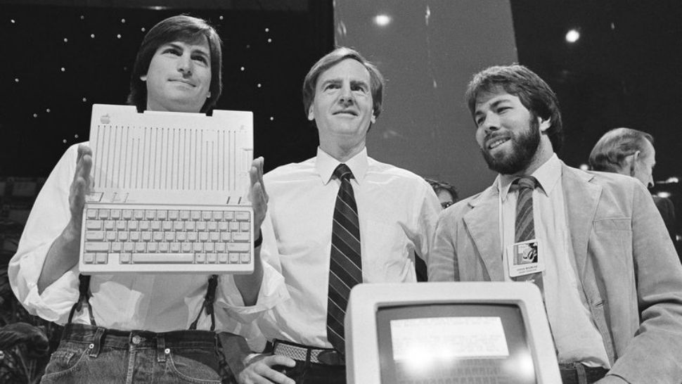 In this April 24, 1984 file photo, Steve Jobs, left, chairman of Apple Computers, John Sculley, center, president and CEO, and Steve Wozniak, co-founder of Apple, unveil the new Apple IIc computer in San Francisco. (Associated Press)