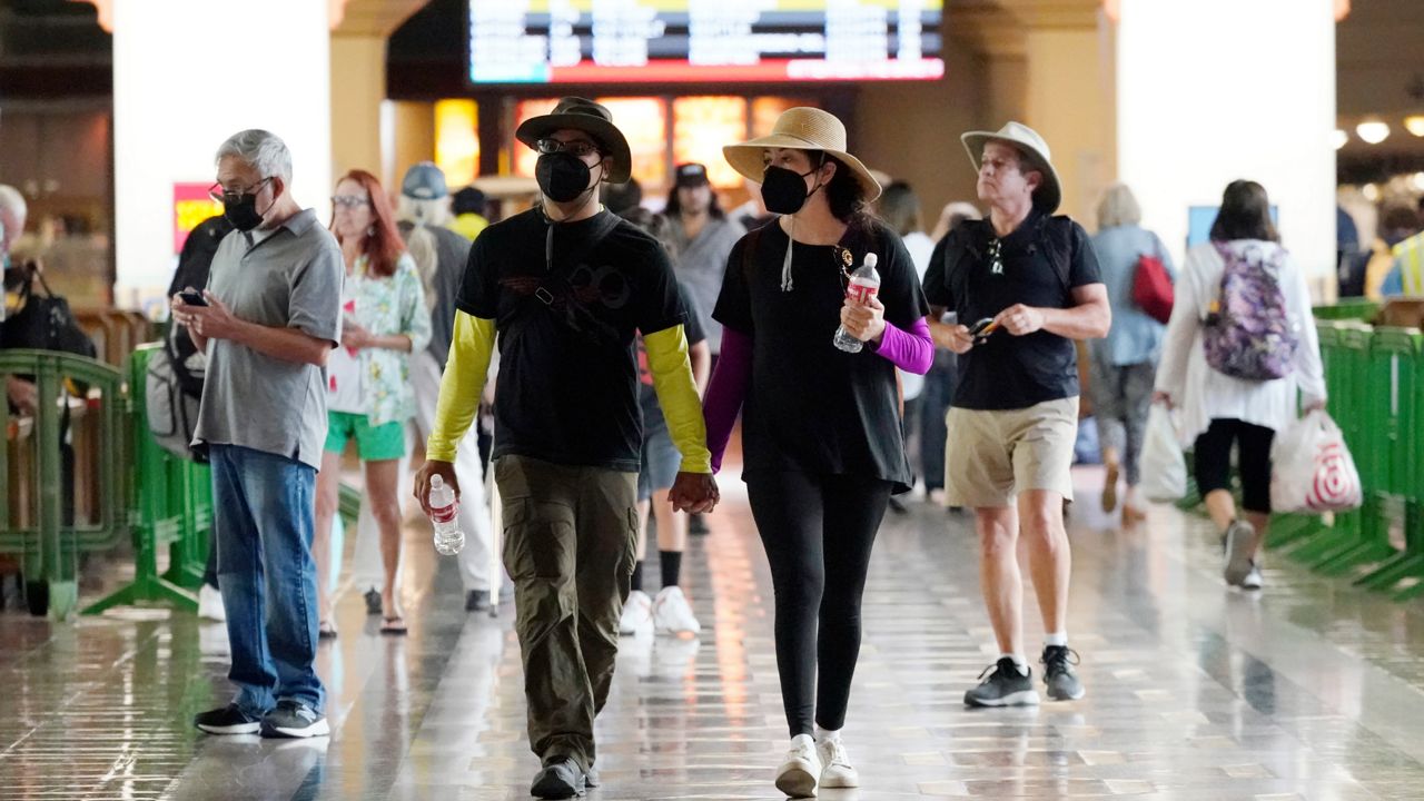 Travelers wear masks inside Union Station Thursday, July 28, 2022, in Los Angeles. (AP Photo/Marcio Jose Sanchez)