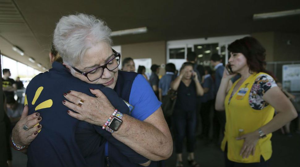 Two women embrace outside of a Walmart where a deadly shooting occurred in El Paso, Texas August 4, 2019 (AP Image)