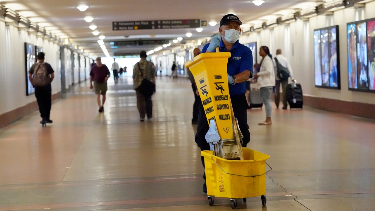 A worker wears a mask inside Union Station Thursday, July 28, 2022, in Los Angeles. (AP Photo/Marcio Jose Sanchez)
