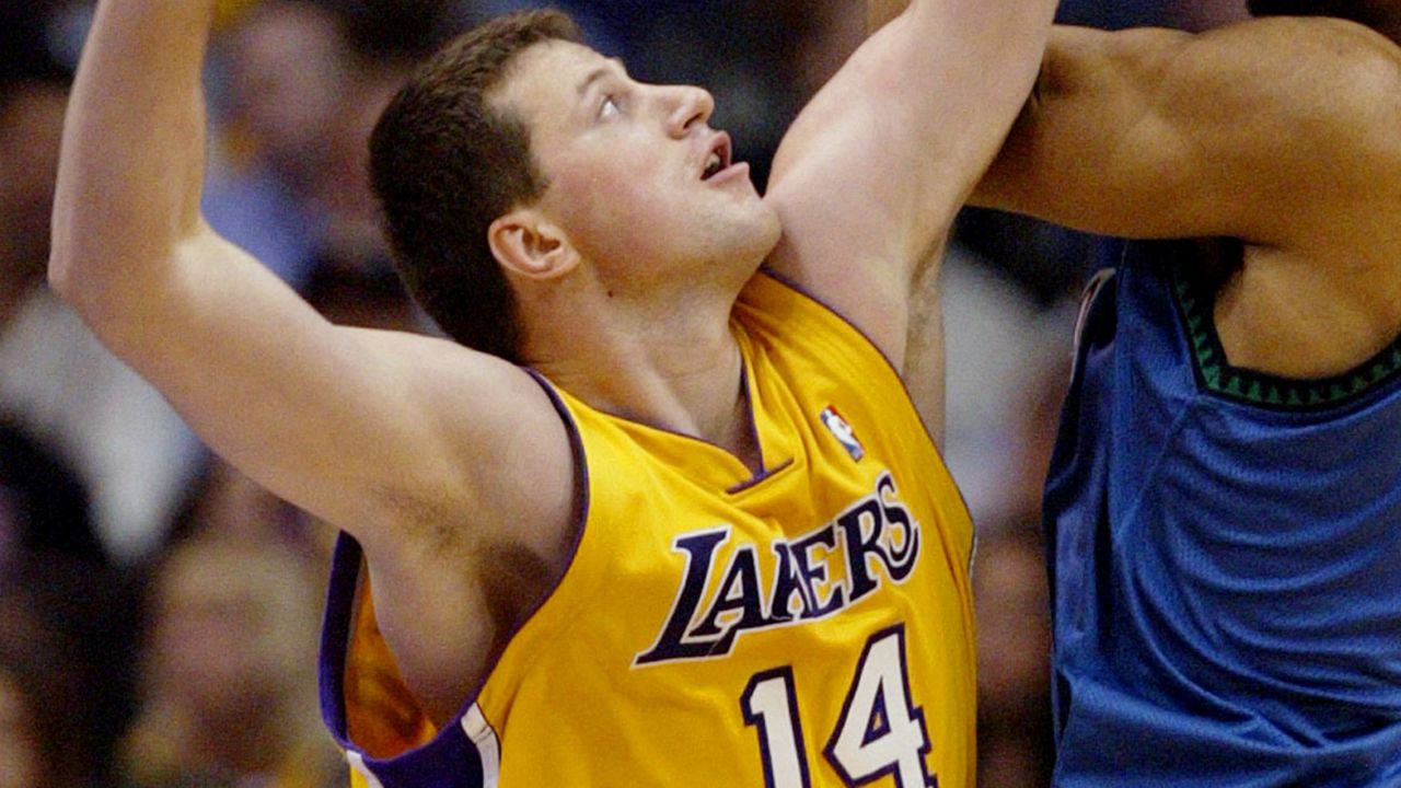Los Angeles Lakers' Slava Medvedenko (14) tries to block Minnesota Timberwolves' Michael Olowokandi (34) during the second quarter of Game 3 of the NBA Western Conference Finals, Tuesday, May 25, 2004, in Los Angeles. (AP Photo/Chris Carlson)