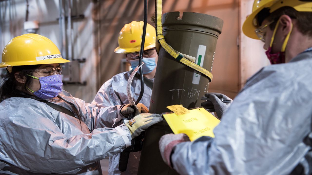 Operators work to place one of the last overpacked 8-inch projectiles containing nerve agent into a tray to begin the destruction process at the Blue Grass Chemical Agent-Destruction Pilot Plant on May 9. The last GB 8-inch projectile was destroyed on May 11, marking the destruction of an entire type of chemical weapon.
