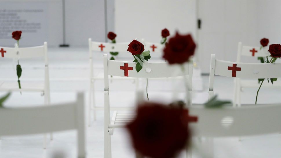 A memorial for the victims of the shooting at Sutherland Springs First Baptist Church, including 26 white chairs each painted with a cross and and rose, is displayed in the church Sunday, Nov. 12, 2017, in Sutherland Springs, Texas. A man opened fire inside the church in the small South Texas community last week, killing more than two dozen. (AP Photo/Eric Gay)